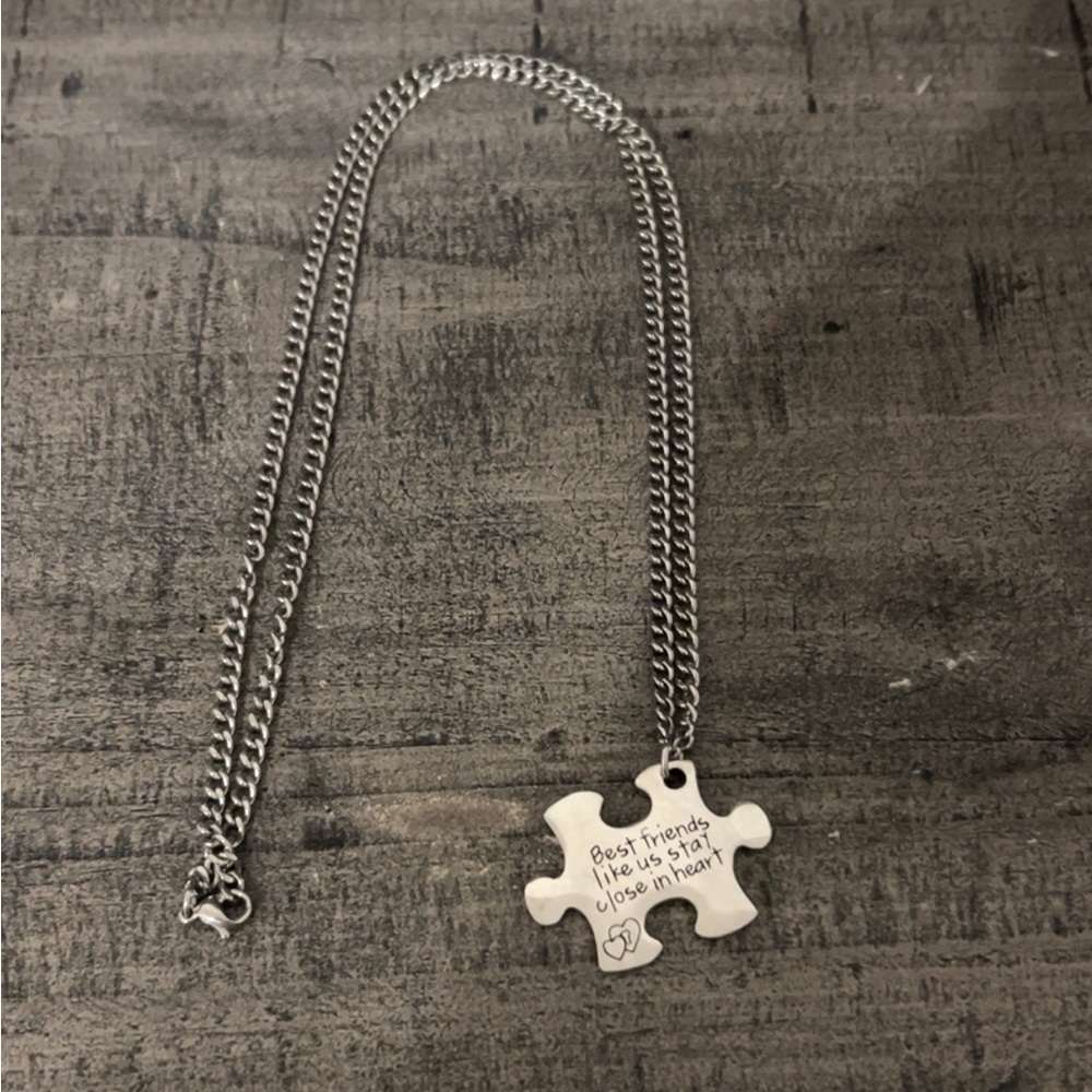Necklace that is sterling silver chain and piece.
